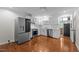 The kitchen features stainless appliances, white cabinets and backsplash, and hardwood flooring at 301 Williamson St, Burlington, NC 27215