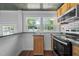 This cozy kitchen features wood cabinets, tile countertops, and stainless steel appliances at 301 Williamson St, Burlington, NC 27215