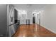 Bright kitchen with stainless steel appliances, white cabinets, and hardwood flooring at 301 Williamson St, Burlington, NC 27215