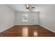 Open living room featuring hardwood floors, ceiling fan, and large windows at 301 Williamson St, Burlington, NC 27215