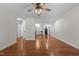 Open-concept living room flows into the kitchen, featuring hardwood floors and neutral paint at 301 Williamson St, Burlington, NC 27215