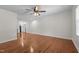 Open living room featuring hardwood floors, ceiling fan, and large windows at 301 Williamson St, Burlington, NC 27215