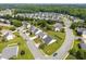 Aerial view of a residential neighborhood with lush green lawns and tree lined streets at 302 Slate Dr, Gibsonville, NC 27249