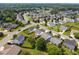 Aerial view of a residential neighborhood with lush green lawns and tree lined streets at 302 Slate Dr, Gibsonville, NC 27249