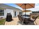 Outdoor patio with a table and chairs, comfortable seating, and a BBQ at 302 Slate Dr, Gibsonville, NC 27249
