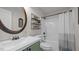 This bathroom has a decorated vanity with olive green cabinets and a shower and bathtub combo at 302 Slate Dr, Gibsonville, NC 27249