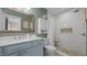Updated bathroom showcasing a vanity with marble countertop and tiled shower with built-in seat at 302 Slate Dr, Gibsonville, NC 27249