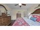 Cozy bedroom features ceiling fan, wooden furniture, and neutral paint at 302 Slate Dr, Gibsonville, NC 27249