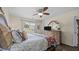 Bright bedroom with ceiling fan, wood floors, and a view of the neighborhood at 302 Slate Dr, Gibsonville, NC 27249