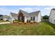 Charming one-story home with well-manicured front yard, lush lawn, and classic white siding at 302 Slate Dr, Gibsonville, NC 27249