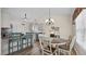 Eat-in kitchen features pendant lighting, breakfast bar, and white cabinets at 302 Slate Dr, Gibsonville, NC 27249