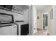 This laundry room has a white washer and dryer set, along with a metal shelving unit at 302 Slate Dr, Gibsonville, NC 27249