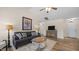 Comfortable living room with ceiling fan, dark grey sofa, decorative pillows, and wood floors at 302 Slate Dr, Gibsonville, NC 27249