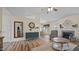 Open-concept living room seamlessly flowing into the dining area, with a fireplace at 302 Slate Dr, Gibsonville, NC 27249