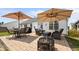 Outdoor patio with two large umbrellas, a table and chairs, comfortable seating, and a firepit at 302 Slate Dr, Gibsonville, NC 27249