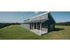 Beautiful modern home with gray siding, black trim, and a spacious covered porch nestled on a grassy hilltop at 345 Wake County Line Rd, Zebulon, NC 27597