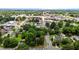 Expansive aerial view of a town featuring lush greenery, roads with cars, and buildings of varying sizes at 347 W Trade St, Burlington, NC 27217