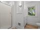 Bright bathroom featuring a glass shower stall and a single sink vanity near a window at 347 W Trade St, Burlington, NC 27217