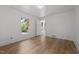 Bright bedroom with wood-look floors, white walls, and open doorways creating an airy, connected living space at 347 W Trade St, Burlington, NC 27217
