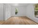 Bright bedroom with wood-look floors and windows, offering a flexible space for relaxation or work at 347 W Trade St, Burlington, NC 27217