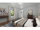 Bright bedroom featuring modern decor, a window view, and light wood flooring for a serene retreat at 347 W Trade St, Burlington, NC 27217