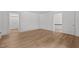 Bright bedroom with wood-look floors, white walls, and open doorways creating an airy, connected living space at 347 W Trade St, Burlington, NC 27217