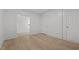 Neutral bedroom featuring light wood floors, white walls, and white trim at 347 W Trade St, Burlington, NC 27217