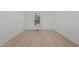A bright and airy bedroom with light wood floors, a window, and white walls at 347 W Trade St, Burlington, NC 27217