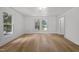 Spacious bedroom with two large windows bringing in natural light and wood-look floors at 347 W Trade St, Burlington, NC 27217