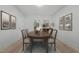 Bright dining room showcasing wooden table, upholstered chairs, decorative art, and natural light at 347 W Trade St, Burlington, NC 27217