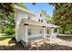 Side view of a charming two-story home with a white exterior and inviting front porch at 347 W Trade St, Burlington, NC 27217