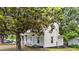 Charming two-story home with a classic design, surrounded by mature trees and a well-maintained lawn at 347 W Trade St, Burlington, NC 27217