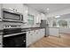 Modern kitchen features stainless appliances, white cabinets, and durable dark countertop at 347 W Trade St, Burlington, NC 27217