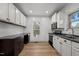 Well-lit kitchen with white cabinets, stainless steel appliances, and hardwood floors at 347 W Trade St, Burlington, NC 27217