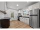 Well-lit kitchen with white cabinets, stainless steel appliances, and modern fixtures at 347 W Trade St, Burlington, NC 27217
