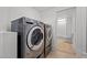Laundry area featuring modern washer and dryer, complemented by easy access to the adjacent bathroom at 347 W Trade St, Burlington, NC 27217