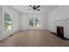 Bright living room with large windows, a decorative fireplace, and hardwood floors at 347 W Trade St, Burlington, NC 27217
