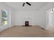 Bright living room with a decorative fireplace, hardwood floors, and ample natural light at 347 W Trade St, Burlington, NC 27217