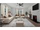 Bright living room with neutral tones, featuring a decorative fireplace and stylish furniture at 347 W Trade St, Burlington, NC 27217