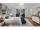 Comfortable main bedroom with natural light, neutral decor, and light wood flooring for a serene retreat at 347 W Trade St, Burlington, NC 27217