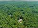 An aerial view of a private property surrounded by mature shade trees showcasing a large forest and the home at 3707 Stonegate Dr, Chapel Hill, NC 27516
