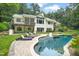 Stunning backyard with a sparkling pool, lounge chairs, and an expansive patio area perfect for outdoor entertaining at 3707 Stonegate Dr, Chapel Hill, NC 27516