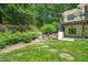 View of the backyard with stone steps and lush landscaping at 3707 Stonegate Dr, Chapel Hill, NC 27516