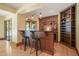Stylish bar area complete with a stone accent wall, wine rack, and stools, perfect for entertaining at 3707 Stonegate Dr, Chapel Hill, NC 27516