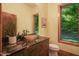 Stylish bathroom with a unique glass bowl sink and natural light from the adjacent window at 3707 Stonegate Dr, Chapel Hill, NC 27516