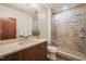 Bathroom with a stone-tiled shower with glass door, a vanity with ample storage, and modern fixtures at 3707 Stonegate Dr, Chapel Hill, NC 27516