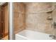 Tiled bathtub with modern fixtures and an in-shower shelf provides convenience and a clean aesthetic at 3707 Stonegate Dr, Chapel Hill, NC 27516