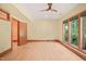 Well-lit bonus room boasting hardwood floors, large windows, and a modern ceiling fan at 3707 Stonegate Dr, Chapel Hill, NC 27516
