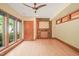 Bright bonus room featuring hardwood floors, large windows, and a unique stone fireplace at 3707 Stonegate Dr, Chapel Hill, NC 27516