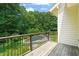 Second story deck with views of the in ground pool and lush green yard at 3707 Stonegate Dr, Chapel Hill, NC 27516